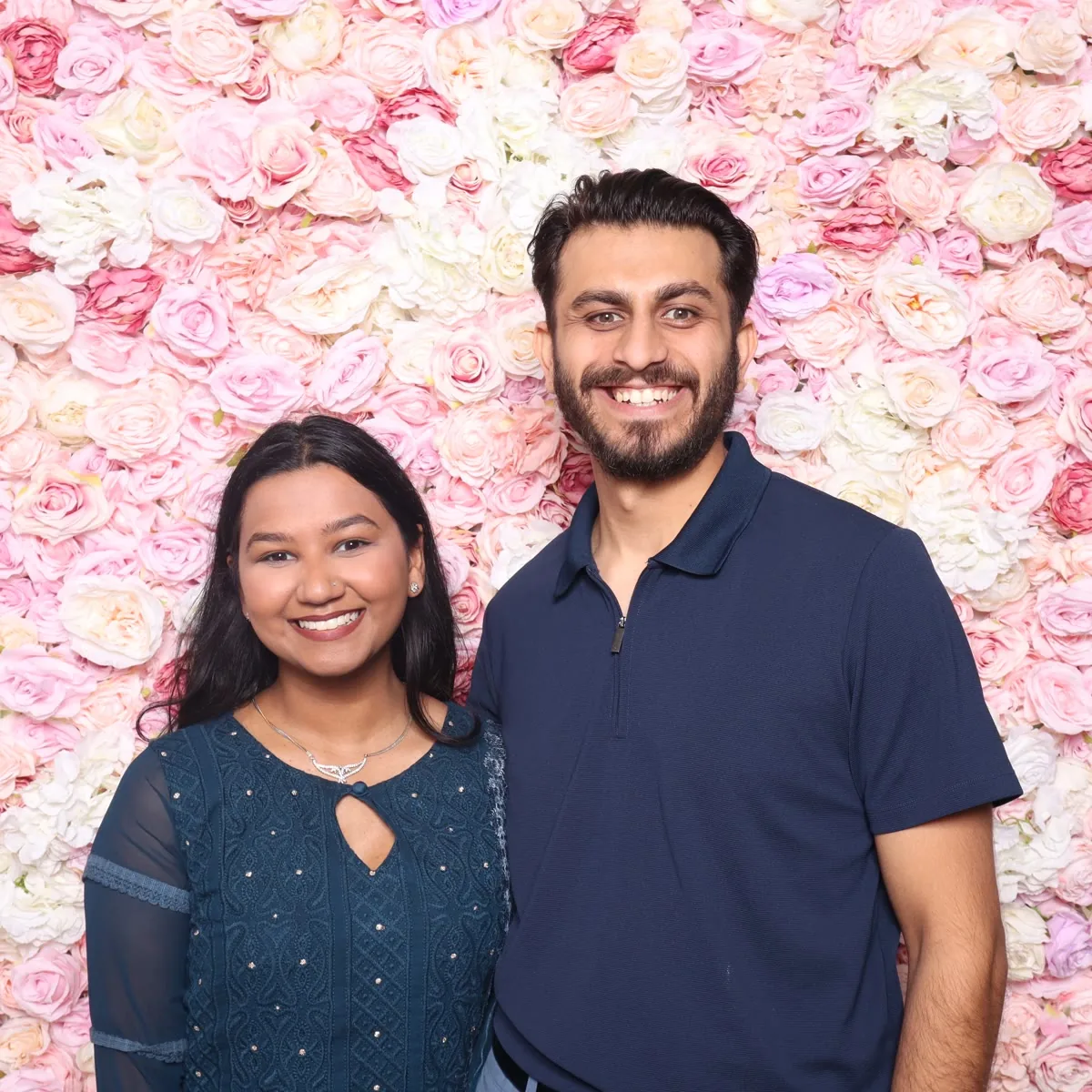 Clutch City luxury booth with neon sign and floral backdrop at Houston event